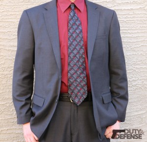 If you wear a suit, you will want to be sure that you choose a holster that works well with a suit, and make sure the suit is tailored to fit your holster. In this case, a Deep Concealment Tuckable holster is worn, with a leather open-top magazine pouch, and a pocket magazine pouch in the front pocket. A sturdy leather holster belt is worn.